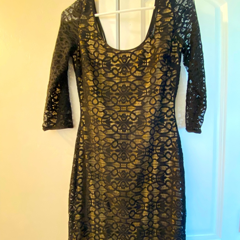 GUESS form fitting black lace dress with a neutral colored tan under the lace